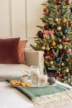 a living room with a christmas tree and cookies