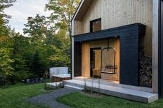 a house that is made out of wood and has a hot tub in the front