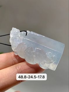 a hand holding a piece of clear plastic with black string attached to it and the words, 488 - 424 - 4778