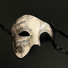 The Phantom mask, known for its association with Venetian parties and extravagant operas that exude history, would also make you stand out in any other gathering. Luxury Masks For Costume Party, Silver Full Face Masquerade Mask, Silver Full Face Mask For Masquerade, Venetian Masks And Prosthetics For Halloween Theater, Full Face Silver Masquerade Mask, Vintage Masks For Halloween Costume Party, Vintage Halloween Costume Party Masks, White Formal Masquerade Mask For Carnival, Venetian Mask For Theater Halloween