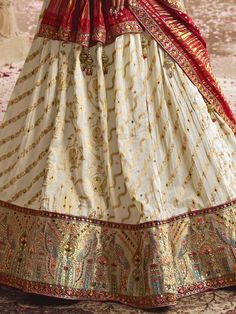 Cherish your golden moments and soak yourself in the spell of our timeless with these graceful off-white color lehengas made of viscose silk material adorned with sequin work, thread, and embroidery work with good-looking peacock motifs. This ravishing off-white lehenga comes with a red color blouse of viscose silk material designed with sequin, thread, and embroidery work. It also comes with a red-color viscose silk material dupatta crafted with bandhani print work and lovely lace border work. Lehenga White, Peacock Motifs, Bandhani Print, White Lehenga, Golden Moments, Color Blouse, Red Lehenga, The Spell, Lace Border