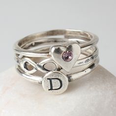 "Don't you just \"love\" this?! Stack the love and get one ring to represent each person in your family. Our heart birthstone ring is perfect for the mother or grandmother of one, or to wear yourself to represent your own birthstone. Wear just one or add more to your stack to represent the favorite people in your life that mean so much to you! This listing is for one stackable sterling silver and 2mm Swarovski crystal birthstone heart ring. Want to add more shapes to your stack? Create your own Personalized Silver Birthstone Ring For Valentine's Day, Personalized Silver Heart Cut Birthstone Ring, Heart-shaped Adjustable Birthstone Ring, Adjustable Heart-shaped Birthstone Ring, Adjustable Heart Shaped Birthstone Ring, Heart-shaped Adjustable Birthstone Wedding Ring, Adjustable Heart-shaped Birthstone Wedding Ring, Heart-shaped Birthstone Wedding Ring, Personalized Silver Heart-shaped Birthstone Ring