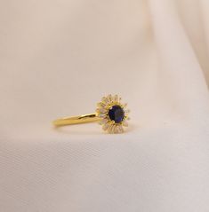 🌻 Introducing our stunning Sapphire Sunflower Ring, a delicate and captivating piece that will beautifully adorn your finger. This dainty gold plated ring exudes elegance and charm, making it an ideal choice for any occasion. Whether it's an anniversary celebration, a stylish stacking ring, an engagement symbol, or a promise of eternal love, this exquisite piece is the perfect fit. 🌼 ✨ Crafted with meticulous attention to detail, this gold plated ring features a captivating sunflower design th Dainty Crystal Ring For Proposal, Dainty Gemstone Cluster Ring, Dainty Oval Gold-plated Ring, Dainty Open Crystal Ring For Proposal, Dainty Oval Gold Plated Rings, Delicate Gold Flower Ring With Gemstone, Dainty Gold Plated Diamond Ring, Dainty Gold Cubic Zirconia Cluster Ring, Delicate Gold Ring For Proposal