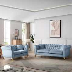 a living room with two blue couches and a coffee table