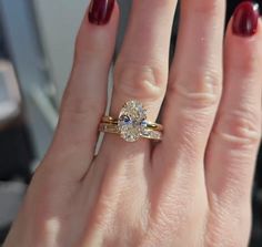 a close up of a person's hand with a ring on it