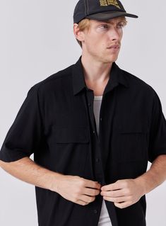 The Crepe Shirt in Black is designed to be your next trans-seasonal wardrobe staple constructed from 100% Cotton crepe. Layer it up over a tee or tank for a more casual look and button it up when the formalities kick in. Classic Collar Double Chest Pockets Oversized Fit Modern Black Summer Shirt, Rayon Shirt With Shirttail Hem For Spring, Spring Rayon Shirt With Shirttail Hem, Classic Collared Rayon Tops, Summer Rayon Shirt With Shirttail Hem, Modern Tops With Rolled Sleeves For Spring, Black Semi-formal Tops For Summer, Black Semi-formal Summer Top, Modern Semi-formal Tops With Short Sleeves