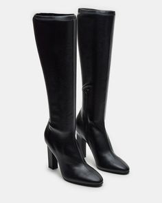 Elevate your style with our ARIA knee-high heeled boot. Crafted with a sleek design, these boots will add a touch of sophistication to any outfit. You can confidently step out in style with a comfortable heel height and secure fit. Perfect for any fashion-forward individual. 4 inch heel height Size 6 measurements: 13.5 Trendy Fitted Knee-high Boots With Reinforced Heel, Tall Boots With Reinforced Heel, Fitted Tall Knee-high Boots With Reinforced Heel, Trendy Wide Calf Knee-high Boots With High Ankle, Winter Knee-high Boots With Sculpted Heel For Wide Calves, Classic Knee-high Boots With High Heel, Knee-high Boots With Sculpted Heel, Classic High Heel Knee-high Boots, Trendy High Heel Boots For Workwear