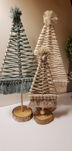 two small christmas trees made out of wickers and wood slices on a table