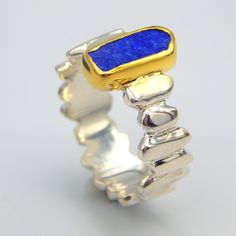 Raw Lapis Lazuli statement ring made out of 18 karat Gold plated Sterling Silver. 100% Handmade Jewellery. LAPIS LAZULI: The sweet sounding name of this gem is composed of 'Lapis', the Latin word for stone, and 'Azula', which comes from the Arabic and means 'blue'. Historians believe the link between humans and lapis lazuli stretches back more than 6,500 years. The gem was treasured by the ancient civilizations of Mesopotamia, Egypt, China, Greece, and Rome. They valued it for its vivid, exquisi Modernist Blue Gemstone Jewelry, Unique Yellow Gold Sterling Silver Gemstones, Modernist Gemstone Jewelry For Gifts, Modernist Blue Jewelry As Gift, Blue Modernist Jewelry For Gift, Modernist Blue Jewelry For Gift, Modernist Blue Jewelry Gift, Blue Sterling Silver Fusion Rings, Fusion Style Blue Sterling Silver Rings