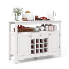 a white buffet table with food and drinks on it's top shelf in front of the counter