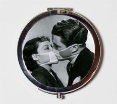 a man and woman kissing in front of a mirror with an ad for the camera