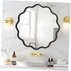 a bathroom with a sink, mirror and gold faucet lights on the wall