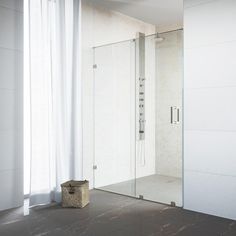 a bathroom with a walk in shower next to a white curtained wall and floor