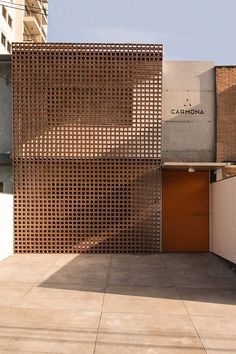 the building is made out of wood and has an orange door in front of it