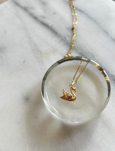 My Handmade Swan Pendant Necklace is elegant and romantic! Crafted on an anti-tarnish gold-plated chain that sparkles with every movement, this necklace exudes subtle glamour. The centerpiece is a stunning gold-plated swan pendant, adding a touch of sophistication to any outfit. Whether you're dressing up for a special occasion or adding a bit of glamour to your everyday look, this necklace is sure to make a statement. Handmade with care, it offers both style and quality. Swan Jewelry, Swan Pendant, Grandmillenial Style, Gold Swan, Swan Necklace, Silver Swan, Romantic Jewelry, Necklace Elegant, Romantic Jewellery