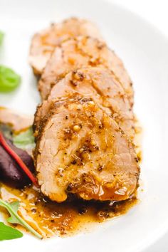 a white plate topped with meat and vegetables