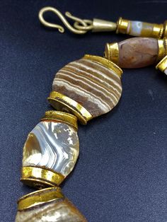 The Rare Unique Bactrian Banded Agate Beads Necklace Circa Late 3RD-EARLY 2ND MILLENNIUM B.C very rare Beads from my Old Collections very rich in patina (rust) Every Bead Got very Big hole The Age of this Beads are more than 2000 Years Old They were used as a special charm Jewelry At that Ancient Times Best gift for the people who collect Ancient Beads and study ancient history Fast and Free Shipping Service World Wide Enjoy Artisan Gold Beads, Gems, And Cabochons, Artisan Gold Gemstone Beads And Cabochons, Luxury Agate Gemstone Beads Necklace, Formal Necklace With Natural Stones And Agate, Formal Agate Necklace With Natural Stones, Gold Agate Beads For Jewelry Making, Luxury Agate Necklace With Natural Stones, Elegant Oval Agate Beads And Cabochons, Elegant Agate Oval Beads