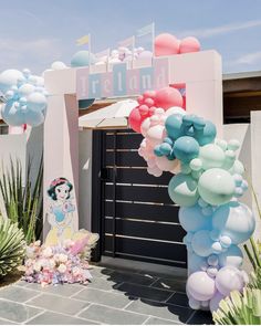 there is a balloon arch in front of the entrance