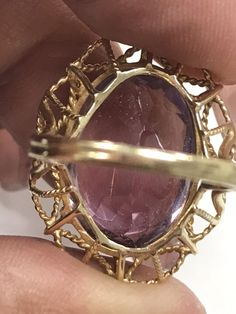 VINTAGE AMETHYST 14K YELLOW GOLD FILIGREE RING Unique and rare design, Fine Oval Amethyst Solitaire Ring approximately 15ct, set in a gorgeous filagree design band. There is a scratch/crack in back of stone. (see pics) Does not go through. It is not really visible from front, I've worn and never noticed until photographing now. Price reflects this. This item is vintage and beautiful that is sure to be one of your favorite pieces! Oval cut Amethyst totaling approximately 15 CTW! Measures approxim Oval Center Stone Gemstones For Formal Occasions, Oval Gemstones With Prong Setting For Formal Occasions, Formal Cabochon Amethyst Ring Fine Jewelry, Oval Diamond-cut Gemstones For Formal Occasions, Formal Amethyst Oval Cabochon Jewelry, Formal Oval Diamond-cut Gemstones, Formal Amethyst Jewelry, Oval Cabochon, Formal 14k Gold Amethyst Ring, Victorian Amethyst Ring With Center Stone In Gold