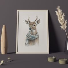 a painting of a deer wearing a scarf next to candles and a vase with flowers