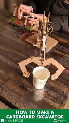 a person working on an electronic device with the words how to make a cardboard excavator