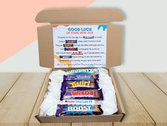 an open box filled with candy on top of a wooden table