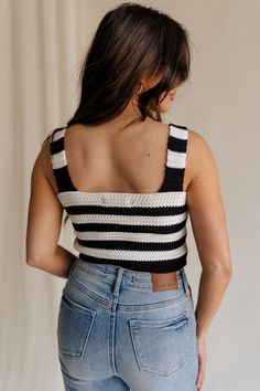 The Kai Black & White Stripe Knit Tank is a perfect blend of timeless style and contemporary flair, designed to make a statement wherever you go. Crafted from a luxurious black and white crochet knit, this tank features a captivating stripe pattern that adds visual interest and texture to your ensemble. The cropped waist silhouette lends a modern touch, perfect for pairing with high-waisted jeans or skirts for a chic look. The rhinestone button-up detailing adds a touch of glamour, elevating the Trendy Striped Knit Tank Top, Fitted Striped Cotton Knit Top, Striped Cotton Sweater Vest For Summer, Fitted Striped Knit Tank Top, Black Sleeveless Knit Crochet Top, Black Sleeveless Crochet Knit Top, Black Cotton Crochet Top, Black And White Crochet, Travel Dress