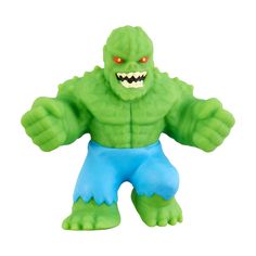 a close up of a toy figure with an evil face and green body, on a white background