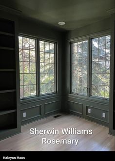 an empty room with wood floors and green walls