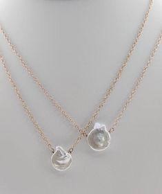 This necklace is a delicate and captivating tribute to the coastal beauty of the ocean's edge. Each Pacific Shell Necklace features meticulously chosen shells, thoughtfully arranged to create a harmonious and timeless piece of jewelry. The shells are a reflection of nature's artistry, with their unique shapes and textures mirroring the ocean's treasures. This necklace is a celebration of graceful simplicity, making it a versatile and elegant addition to your collection. Shell-shaped Pearl Charm Necklace, Shell Jewelry With Pearl Pendant, Shell-shaped Pearl Chain Necklace, Pearl White Shell Necklace With Pearl Pendant, Shell Clavicle Chain Jewelry, Ocean-inspired Shell-shaped Pearl Pendant Jewelry, White Shell-shaped Pearl Pendant Jewelry, Shell Pendant Jewelry With Pearl Charm, Elegant Shell-shaped Necklace With Pearl Charm