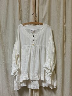 Vintage-inspired breezy linen blouse. This swoon-worthy top features a h Indulge in boho chic with our Artist Top in Linen. This free-spirited classic features a timeless three-button henley neck, side pockets, perfect for showcasing your unique style. (Don't worry, no need to be a master of art!) Made in USA Fit Generous sizing. Fabric has no stretch S M L XL Bust 46” 48” 50” 52” Length Front 27” 27” 27” 27” Length Back 31” 31” 31” 31” Recycled Clothing, Linen Shirts, Bohemian Tops, Recycle Clothes, Romantic Dress, Linen Blouse, Free Spirited, Boho Blouses, Character Outfits