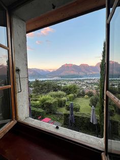 an open window looking out at the mountains