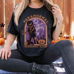 For lovers of all things spooky and paranormal Comfort Colors® 1717Unisex T shirt.  *Medium fabric  *For an oversized fit please order a size or 2 up *100% ring-spun cotton Care Instructions: *Machine wash cold inside out, Do not bleach; Tumble dry on low heat, Iron on low heat inside out and not directly on the design. Do not dry clean. Important Information: *Since shirts are made to order we cannot accept returns or exchanges. If there is an issue with your order just reach out! *Thank you fo Retro Halloween T-shirt With Character Print, Retro Halloween Fan Merch T-shirt, Club Tshirt, Midnight Club, Halloween Crewneck, Fall Clothing, Retro Halloween, Halloween T Shirt, For Lovers