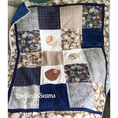 a quilt made to look like baseballs and nuts on a blanket with the words love sewn seams