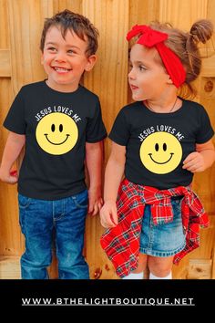 short sleeve black kids tshirt for boys and girls with Christian design on the front.  Large yellow smiley face with "Jesus loves Me" written above the smile face design. Cute Smiley Face Short Sleeve T-shirt, Fun Smiley Face Tops, Christian Kids Shirts, Kids Tshirt Designs, Christian Tshirt Design, Preschool Shirts, Christian Shirts Designs, Faith Clothing, Christian Kids