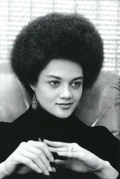 a black and white photo of a woman with an afro