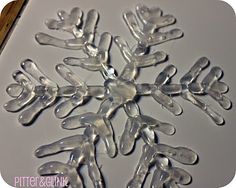 a snowflake made out of plastic sitting on top of a white countertop