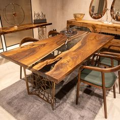 a wooden table surrounded by chairs and mirrors