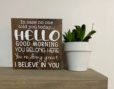 a potted plant sitting on top of a wooden shelf next to a sign that says, in case no one told you today