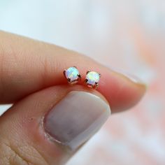 "These dainty opal studs will be your new favorite. They have just the right amount of sparkle and are perfect for a girl who wants something subtle.  ✩\"Single\" means \"one earring\", \"Full pair\" means \"two earrings\" ✩ Made of solid sterling silver ✩ Made to last. Allergy-free. Good for sensitive skin.  ✩ Posts come with a pair of butterfly and clear rubber backs. ✩ 3 mm opal ✩ Ship beautifully packaged More blings from Joylene: https://www.etsy.com/shop/joylenedesign We only choose the finest diamond simulants (CZ 6A) on the market, with a breathtaking level of brightness like real diamonds. Our jewelry can be found in stores and boutiques in Illinois, Indiana and Wisconsin. We always believe that if we invested all of our love and passion into every piece we make, our customers wil Minimalist Opal Earrings, Minimalist Hypoallergenic Opal Earrings, Dainty Opal Earrings For Gift, Dainty Hypoallergenic Opal Earrings, Minimalist Opal Earrings For Gift, Minimalist Opal Earrings As Gift, White Opal Stud Earrings, Opal Stud Earrings, Manual Work