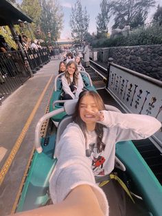 four girls are riding on a roller coaster