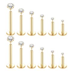 six pairs of gold plated surgical piercings with clear crystal stones on each end