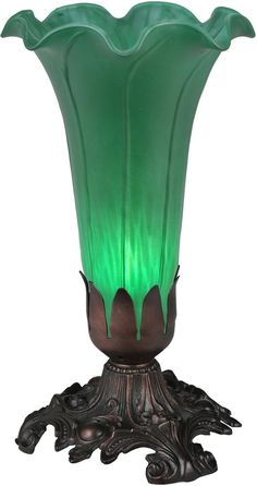 a green vase sitting on top of a wooden stand