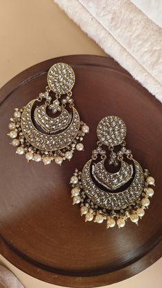 Mirror chandbali earrings/ Kundan earrings /Statement earrings / Bridal earrings/Pearl drop earrings/CZ Jhumka /Bridesmaid Earrings Making Time 10-15 Days Style: Victorian In Personal trust me this is so much beautiful and in great quality, video call also available too see our products. Stunning Sonam Kapoor inspired Jadau Kundan Jhumka statement earrings with green onyx Pearls chains and drops. Perfect to make a statement at weddings. Earrings come with attached sahare (kaanchain) for support High quality and craftsmanship. Closure: Pushback Highest quality and craftsmanship   Women love jewellery; specially artificial jewellery adore a women, They wear it on different occasion, They have special importance on ring ceremony, wedding and festive time, They can also wear it on regular basi Chandbali Earrings Kundan, Pearls Chains, Kundan Jhumka, Pearl Drop Earrings Bridal, Earrings Kundan, Earrings Pearl Drop, Stained Glass Earrings, Jewellery Photography Inspiration, Fancy Jewellery Designs