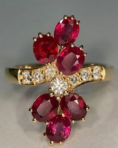 Luxury Ruby Flower Ring In Fine Jewelry Style, Luxury Cluster Ruby Ring For Anniversary, Unique Prong Setting Diamond Ring For Formal Occasions, Exquisite Diamond Cut Ruby Ring For Formal Occasions, Exquisite Yellow Gold Collectible Rings, Exquisite Yellow Gold Ruby Ring For Formal Occasions, Exquisite Yellow Gold Ruby Ring For Formal Events, Unique Formal Rings With Prong Setting, Formal Ruby Ring With Diamond