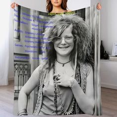 a woman wearing glasses and holding up a large poster with the words, she is smiling