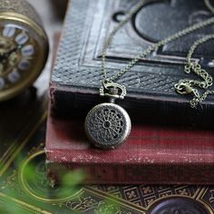 Small 25mm pocket watch necklace with a high quality quartz movement inside. On 26 inches of antiqued brass chain, attached with 2 little Victorian birds. I can make this chain any length for no extra charge. Just leave me a note at checkout! You can adjust the time by pulling up the knob and turning. Pressing the knob opens the watch. Each watch comes in a gift box with instructions and a spare battery. Vintage Metal Pocket Watch Engraved, Vintage Metal Engraved Pocket Watch, Vintage Engraved Metal Pocket Watch, Antique Gold Metal Pocket Watch, Gold Brass Pocket Watch With Antique Finish, Antique Brass Gold Pocket Watch, Vintage Bronze Metal Pocket Watch, Gold Antique Finish Brass Pocket Watch, Vintage Quartz Pocket Watch For Everyday Use