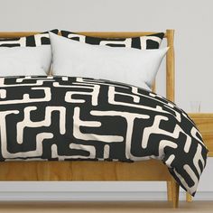 a black and white bed with two pillows