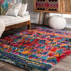 a multicolored area rug in a living room