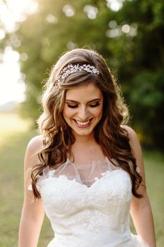 a woman in a wedding dress is smiling